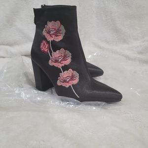 Black ankle booties with rose detailing and gold zipper